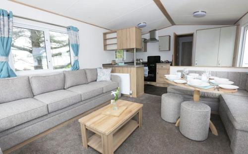 a living room with a couch and a table at Mersea Island by Away Resorts in Colchester