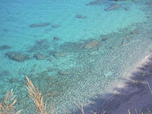 an aerial view of the ocean with rocks and reefs at Borgo Medievale Squillace in Squillace