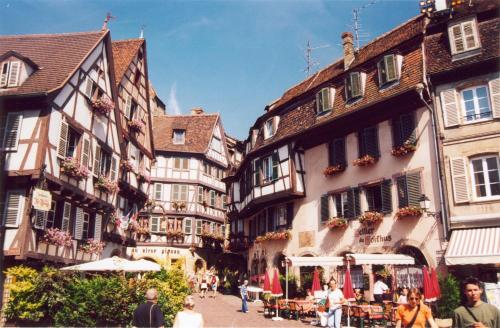 a group of buildings and people walking down a street at 1834&Spa Colmar in Colmar