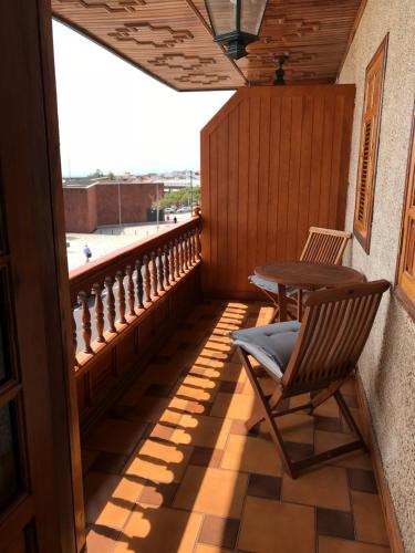 a balcony with a table and a chair on it at Il Sogno di Gio de la Laguna in La Laguna