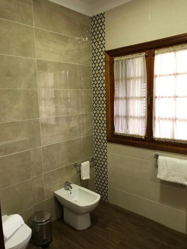 a bathroom with a sink and a toilet and a window at Il Sogno di Gio de la Laguna in La Laguna