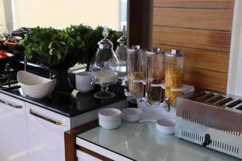 a kitchen with a counter with food on a counter top at Business Grand Hotel in Ankara