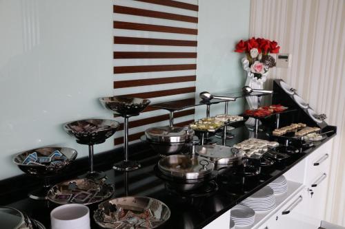 a buffet with many plates and bowls of food at Business Grand Hotel in Ankara