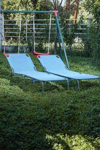 a blue swing set in the grass at Nektarios Garenias Kipoupoli in Nea Kalikratia