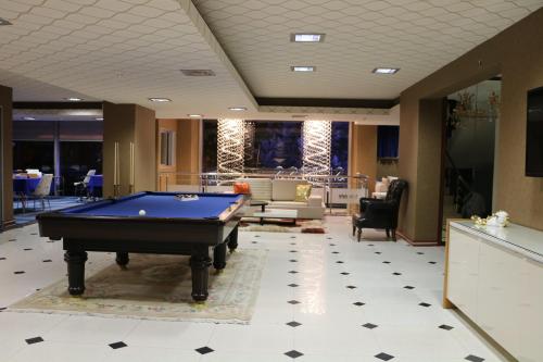 a lobby with a pool table in a room at Business Grand Hotel in Ankara
