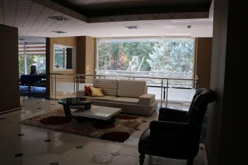 a living room with a couch and a table at Business Grand Hotel in Ankara
