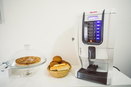 a cookie maker and a basket of bread on a counter at Bluemoon Sardinia in Cagliari