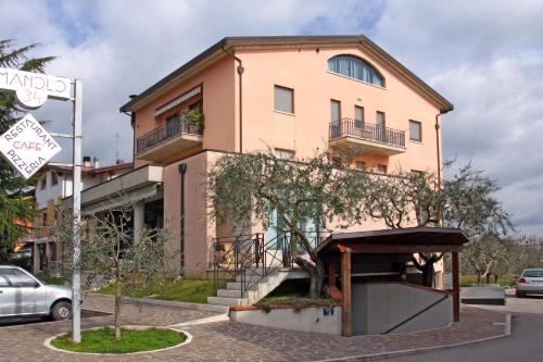 a building with a tree in front of it at Camere Rufino A POCHI CHILOMETRI DAL CENTRO DI PERUGIA E DA ASSISI in Collestrada
