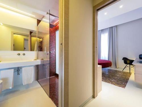 a bathroom with a sink, toilet and bathtub at Duomo Suites & Spa in Catania