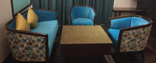 two chairs and a table and a table and chairs at Best Western Maryland in Chandīgarh