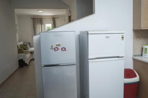 two refrigerators are standing next to each other in a kitchen at Nektarios Garenias Kipoupoli in Nea Kalikratia