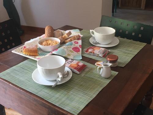 a table with two cups of tea and pastries on it at La Masca in Gaiola