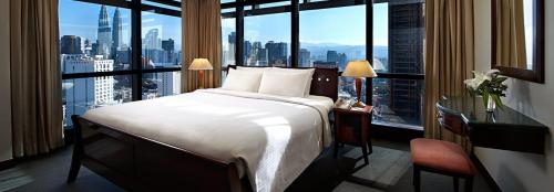 a hotel room with a bed and a large window at Comfort Service Apartment at Times Square KL in Kuala Lumpur