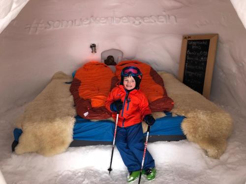 a young child is standing in a snow igloo at Appartements Olympia in Mayrhofen