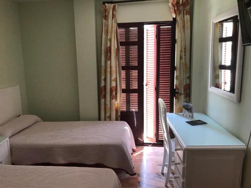 Ένα ή περισσότερα κρεβάτια σε δωμάτιο στο Hostal Rio de Oro