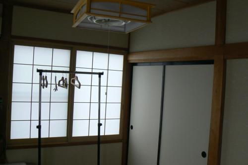 a room with two sliding doors and a window at Fureai No Yado Yasuragi in Nozawa Onsen