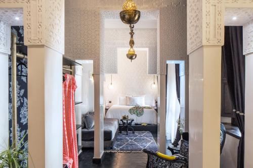 a hotel room with a bed and a living room at Dar Kandi in Marrakech
