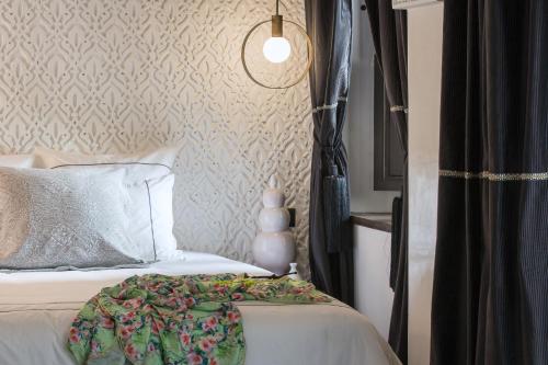 a bedroom with a bed with a pillow and a lamp at Dar Kandi in Marrakech