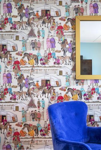 a blue chair in a room with a wallpaper at Thon Hotel Storo in Oslo