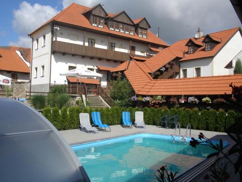a swimming pool in front of a large building at Dalmo in Sedlec