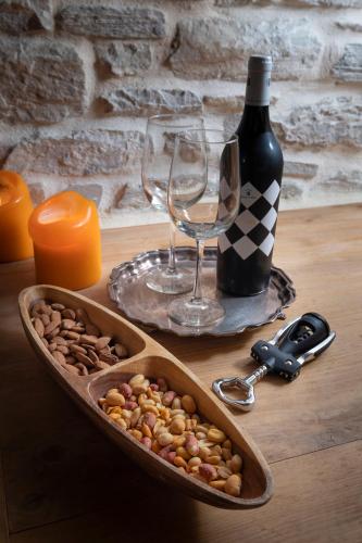 a table with a bowl of nuts and a bottle of wine at Sakali Mansion in Pinakátai