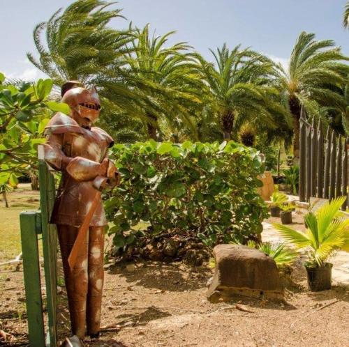 a statue of a man standing next to a fence at South Coast Horizon in Curtain Bluff