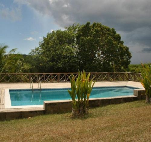 a swimming pool in the middle of a yard at South Coast Horizon in Curtain Bluff