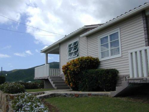 a house with stairs and bushes in front of it at South Coast Horizon in Curtain Bluff