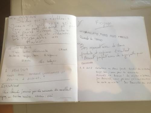 an open book with handwriting on the pages at Les Glycines in Remoulins