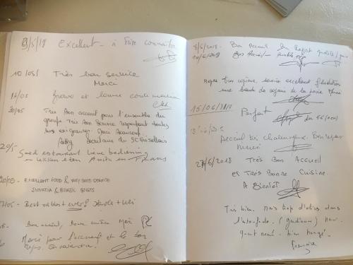 an open book with handwriting on the pages at Les Glycines in Remoulins