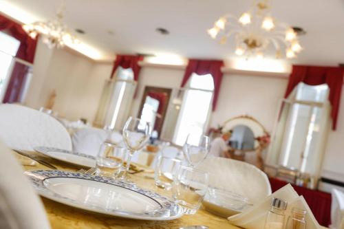 a dining room with a table with wine glasses on it at Hotel Lido in Rimini