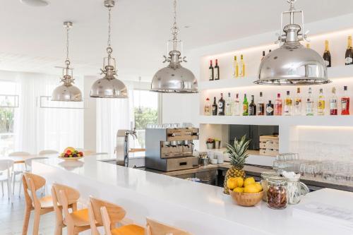 a kitchen with a large white counter with fruit on it at Laguna - Vilamoura in Vilamoura