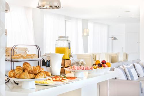 a breakfast table with croissants and other breakfast foods at Laguna - Vilamoura in Vilamoura