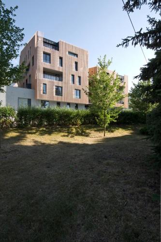 a building with a tree in front of it at Lakepark Residence in Staré Splavy