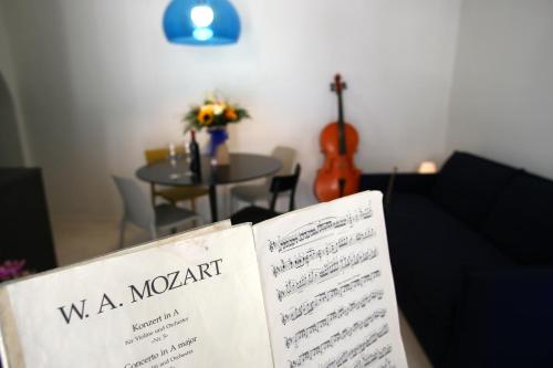 a book sitting on top of a couch with a table at Suite mozart in Vieste