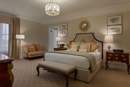a bedroom with a large bed and a living room at Fairmont Copley Plaza in Boston
