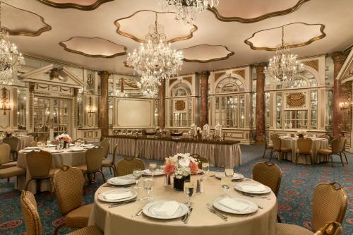 a dining room with tables and chandeliers at Fairmont Copley Plaza in Boston