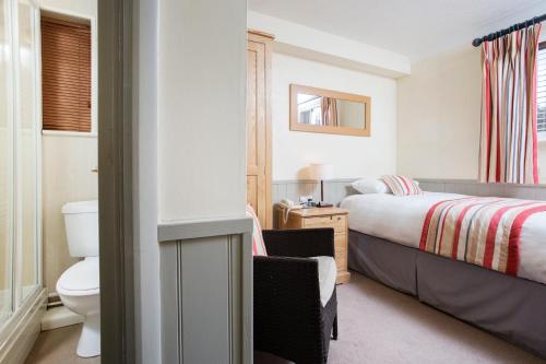a hotel room with a bed and a toilet at Breckland Lodge in Attleborough
