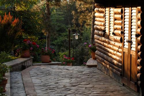 an entrance to a garden with a stone walkway at Hotel Helen in Bacău