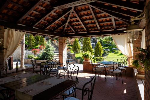 a patio with tables and chairs in a building at Hotel Helen in Bacău