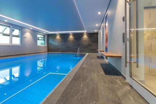 a swimming pool in a house at Hotel im Auerbachtal in Bad Laasphe