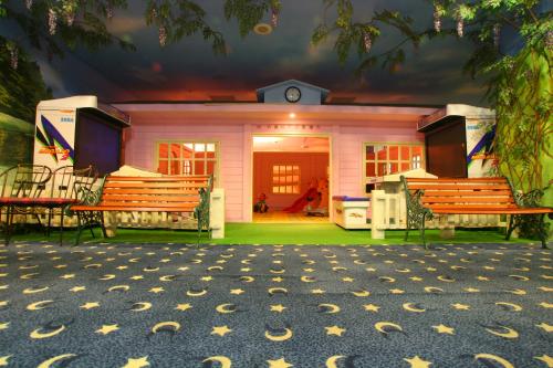 a pink house with benches and stars on the ground at Life Leisure Resort in Guanxi