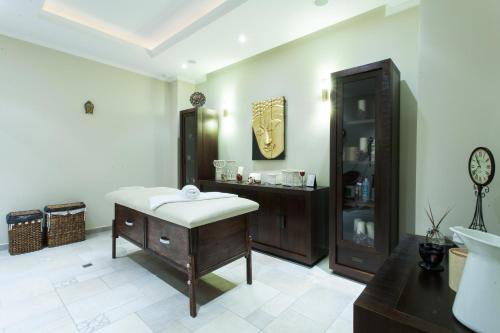 a bathroom with a bath tub and a sink at Hotel Helen in Bacău