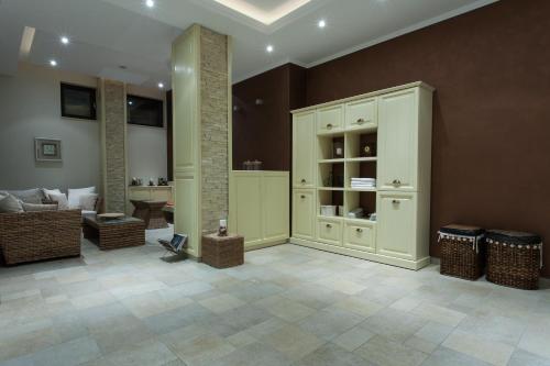 a large living room with a couch and a cabinet at Hotel Helen in Bacău