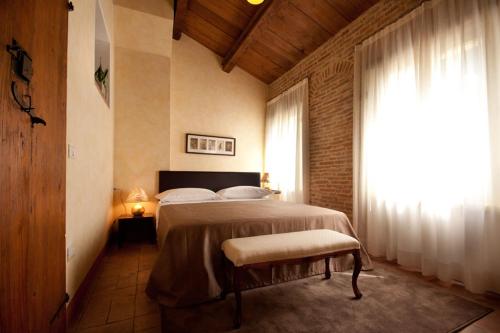 a bedroom with a large bed and a window at Residenza i Platani in Santarcangelo di Romagna