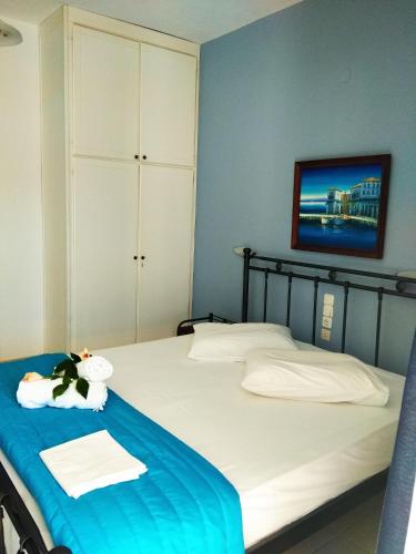 a bedroom with two beds and a tv on the wall at Christina Perlia Studios in Poros