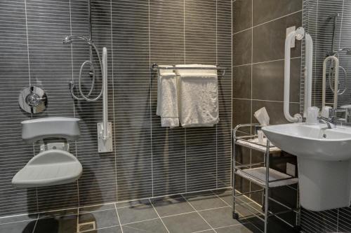 a bathroom with a sink and a toilet and a shower at Linton Lodge a BW Signature Collection Hotel in Oxford