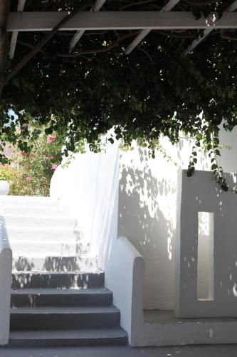 a group of stairs with a tree above them at Ios Plage in Mylopotas