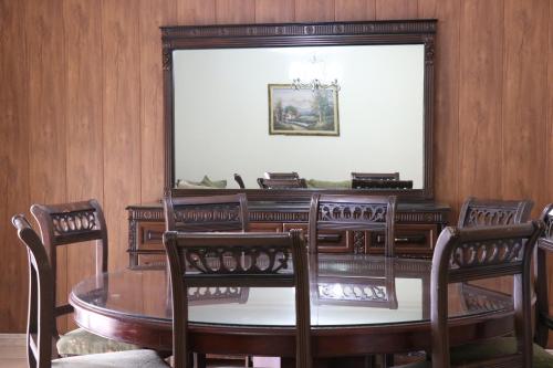 a dining room with a table and chairs at Dynasty Suite in Aley