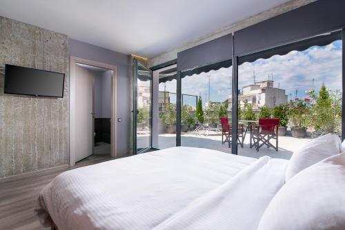 a bedroom with a large bed and a large window at Urban Donkey in Thessaloniki